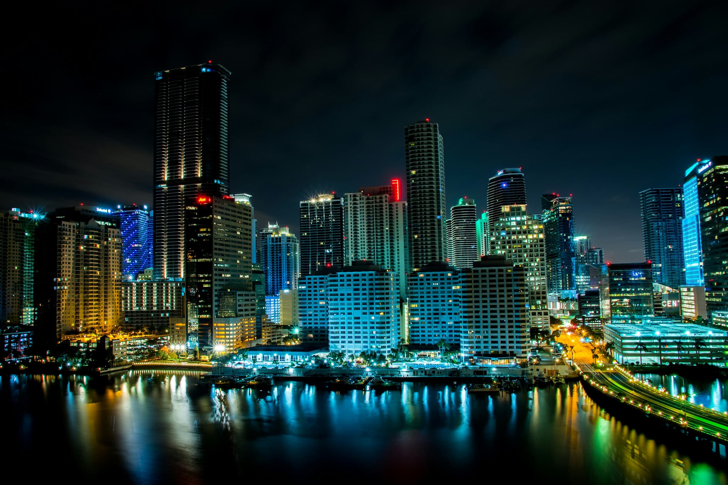 Downtown Miami and Brickell skyline at night, reflected on Biscayne Bay