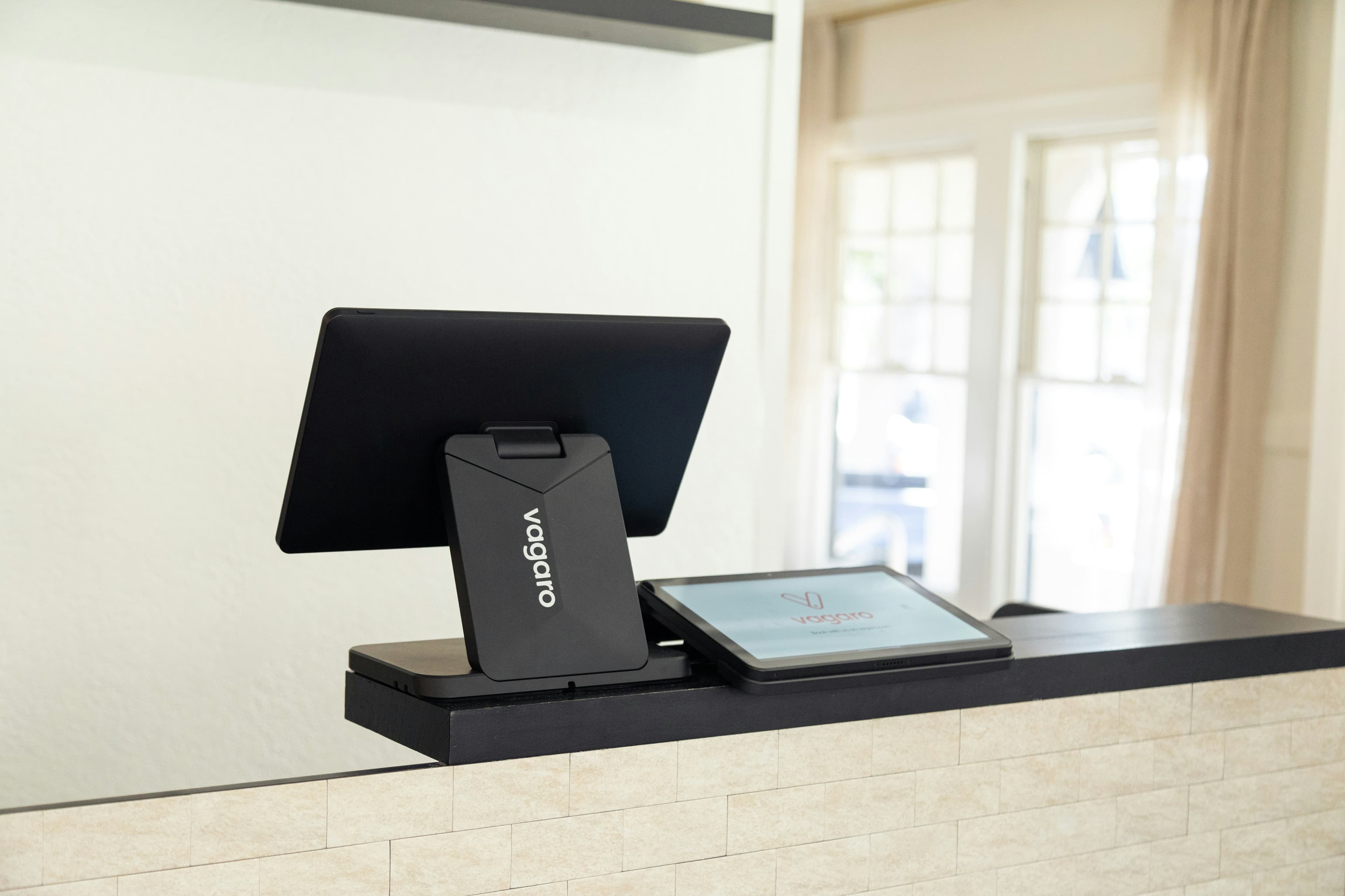 A sleek point-of-sale system is displayed.